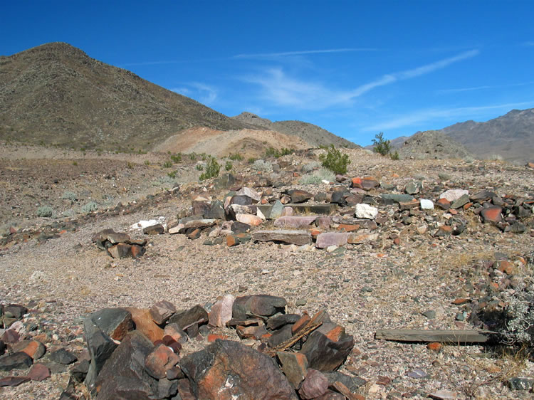 After our return to a spot across the wash from the tin cabin, we notice some stone steps and other evidence of a structure that predated the tin cabin.