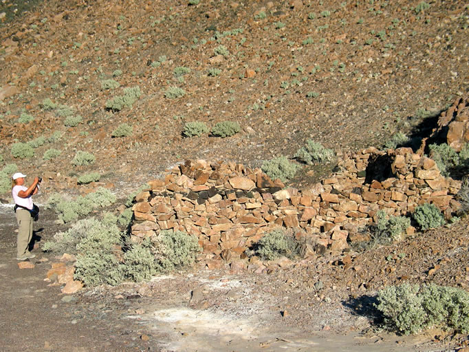 Considering its long and varied history, very little remains in the way of structures.  There are, however, ruins of two stone cabins dating from around 1889.