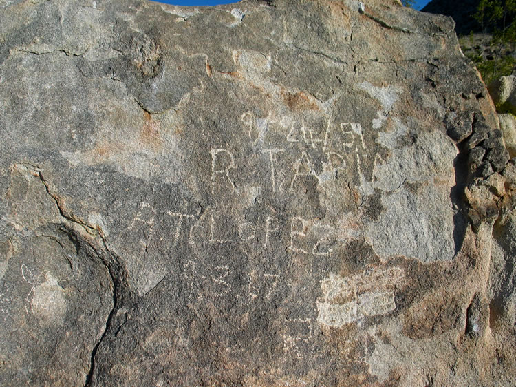 Near the cabin is a large boulder with some historic graffiti on it.