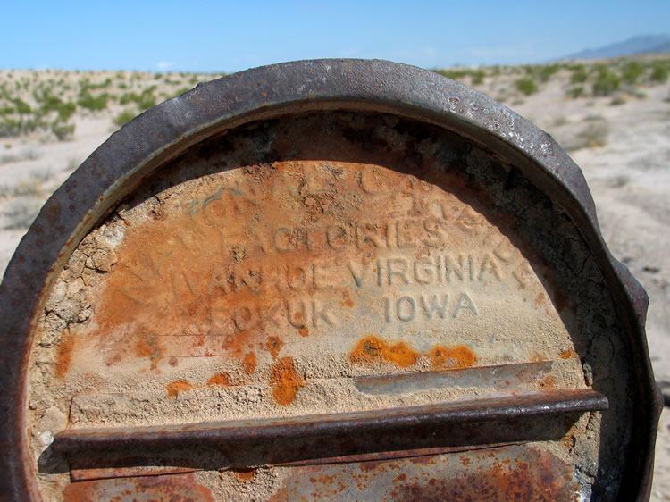 Lids to numerous large carbide barrels litter the ground.  This one says, 