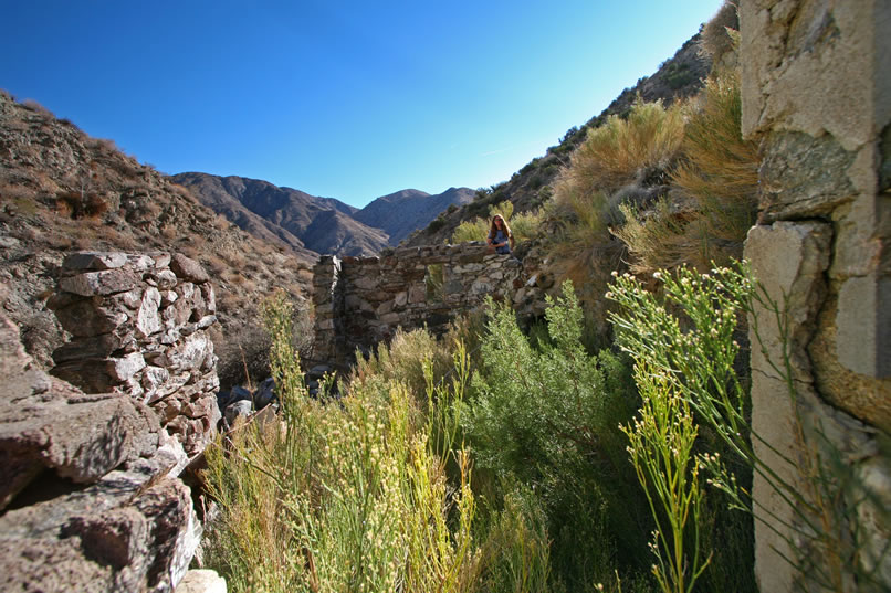 Looking back down canyon and through the main part of the cabin, you can just see Niki, who has made a find.