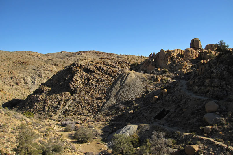 Here's a nice view of the Desert Queen workings as we drop down into the wash to pick up the trail that you see snaking upwards through the mine area.