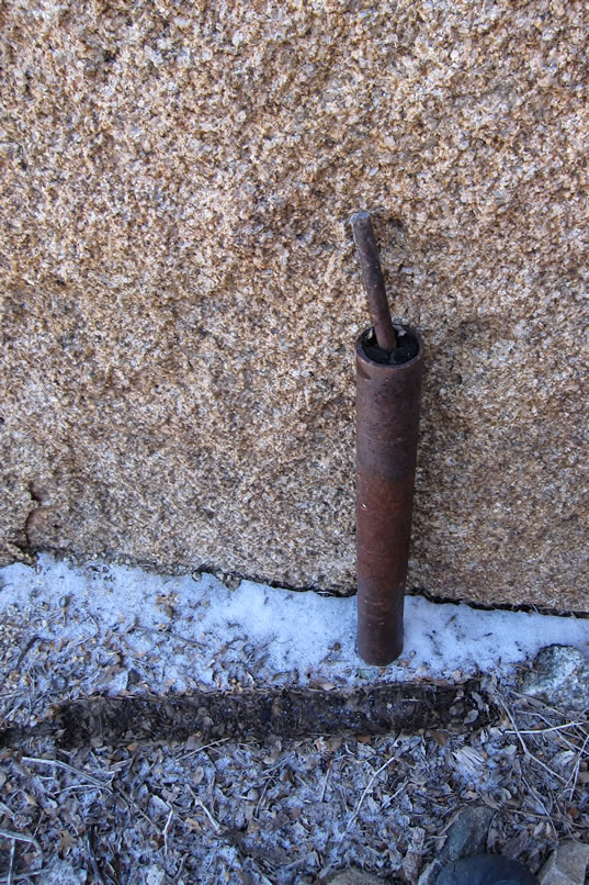 She also spots a piece of metal resting in a snowy patch deeper under the boulders.  It turns out to be a twin of the metal piece that she originally saw sticking out of the top of the nearby boulder.