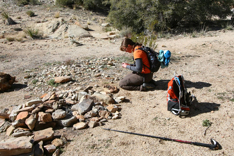 Scattered around in front of the remains of the forge are all sorts of odds and ends associated with a blacksmith's forge.  Here Niki examines a few of her findings.