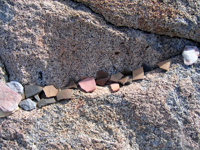 Pottery pieces and morteros were everywhere.  (These were placed here by prior visitors.)