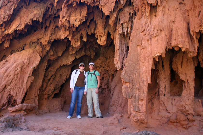The trail to the top of Mooney Falls is easy and short.  Here Joyce and Jenny pose amidst the hanging travertine that has been deposited from the mineralized water.