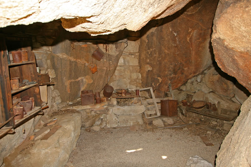 Here you get a good view of the masonry and iron stove built into the far wall of the shelter.  To the left of the photo you can make out part of the shelves and cupboards that are attached to the walls.  All of the artifacts remaining here are original to the site.  Most of the artifacts of interpretive value were curated in 1976 during a scouting trip by the National Park Service LCS (List of Classified Structures) crew.