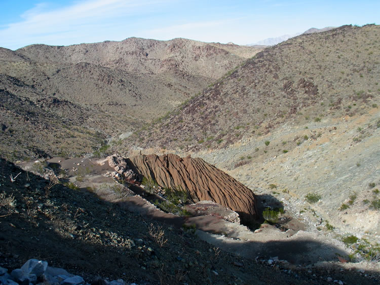 As we crest the ridge we see below the level pads once packed with water tanks, ore bin, cyanide vats, mill, hoist, blacksmith shop, assay office and bunk houses.