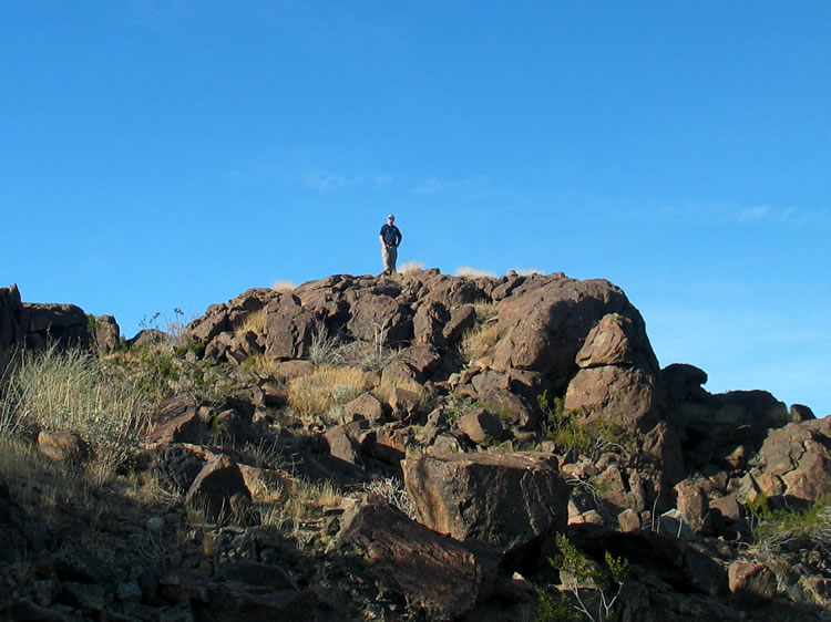 Dan scans the surrounding hills for other mines.