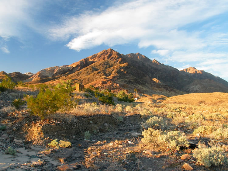 Our plan is to head past Ibex Springs, seen here bathed in sunset glow, and camp on the road to the Moorehouse Mine, the queen of the Ibex talc mines.