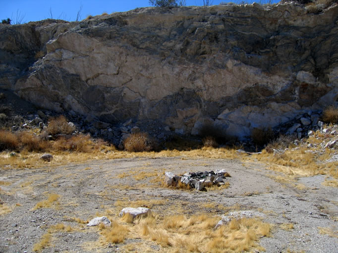 A campsite has been set up in the open pit of the abandoned mine.