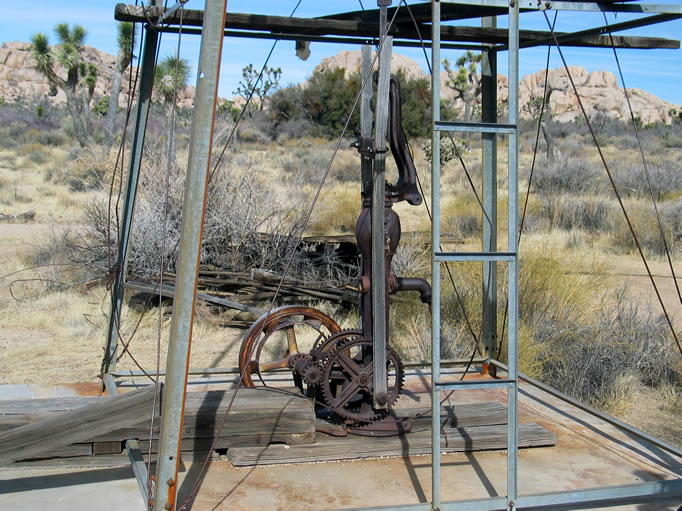 The pump mechanism has been modified to be powered by a belt from a gas engine.