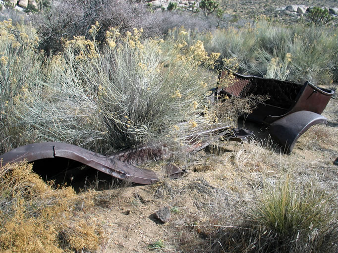 The remains of an old car body alongside the trail.