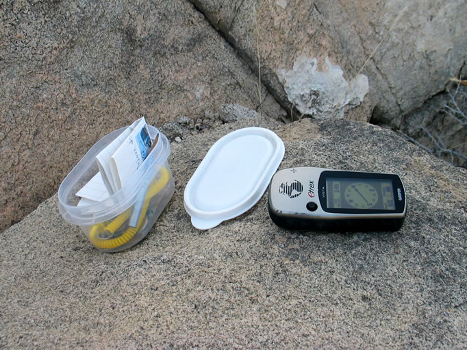 Guy finds the Coyote Hole Springs geocache.