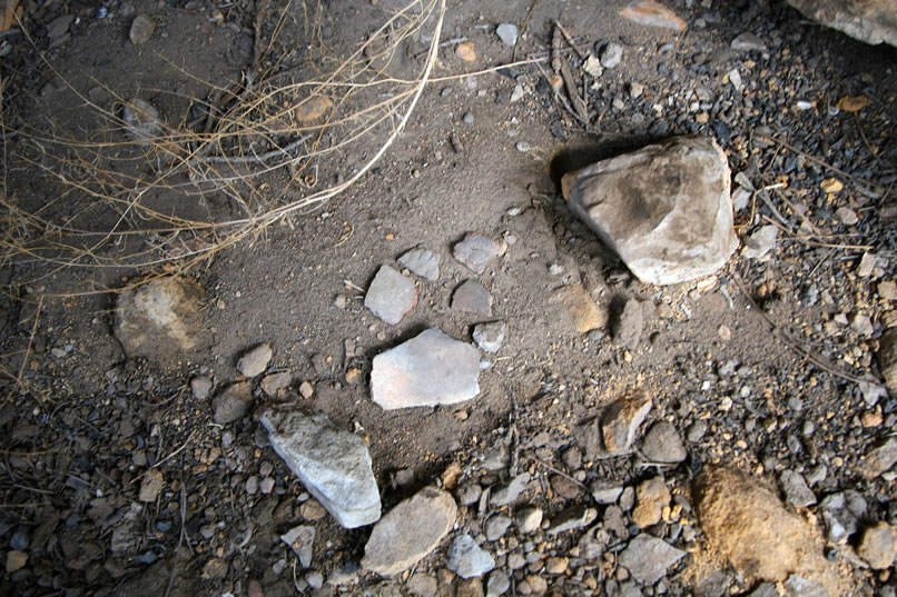 Sure enough, several small pottery fragments, which we've posed here for this photo, are found on the floor of the shelter.