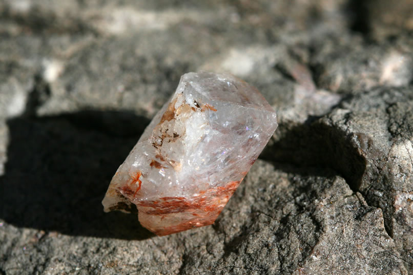 This piece has some interesting reddish inclusions but is lacking defined crystal structure.