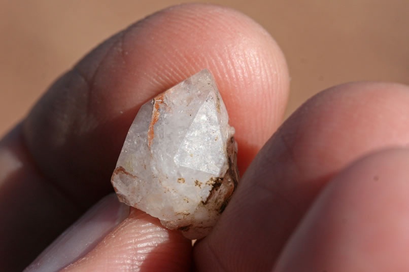 Jamie has found some quartz crystals that have clearly defined points and facets, but they don't have the clarity to make them stand out.