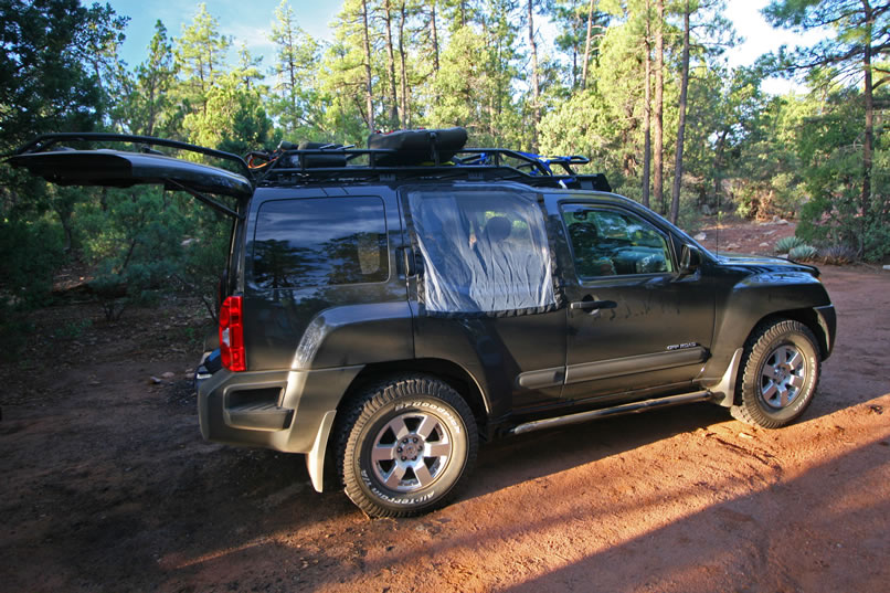 Notice the fine mesh magnetic bug screens that we have over the rear windows.  With these, we can leave the windows down for fresh air and not worry about unwanted bugs getting inside.  You can check 'em out at Magna Screen's website.>