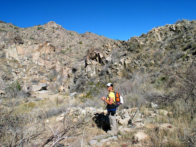 Up canyon and within sight of the trough is the site of the historic New Eldorado Mill.  Here Jamie stands inside the ruins of a rock walled cabin.  The little camp that sprang up here in the 1890's was due to the water and the two stamp mill that processed ore from the nearby mines.