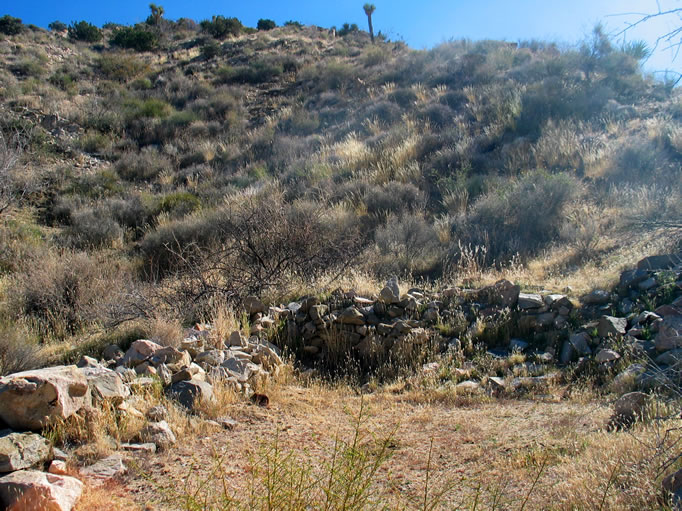 Another view of the cabin site.  Nearby you will find the remains of rock walls and steps, level building sites, as well as scattered debris.  The mill itself was moved in the early 1930's when the mines played out and is now standing in its reincarnated state at the Wall Street Mill.