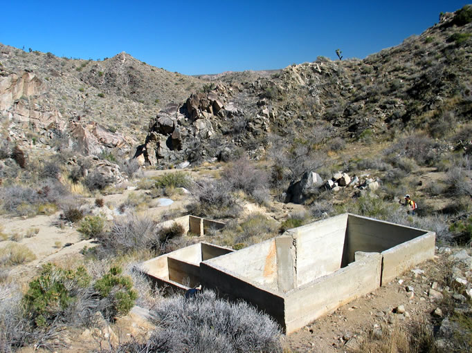 A view to the north of the three stair stepped tanks and the wash below.  The canyon no longer reverberates to the incessant pounding of the stamp mill, but a little imagination can bring it all back.