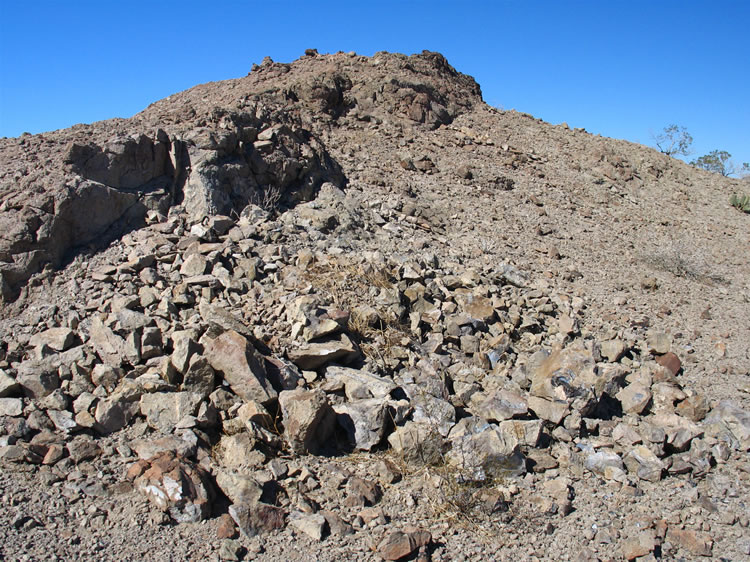 Then Jamie spots what appears to be debris from someone who has been excavating into a rocky hill.