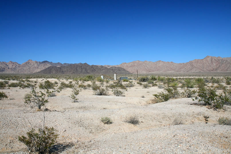 Niki decides to take a look at the old pumping plant at Pinto Well, while Jamie will follow the wash.  This photo shows the Pinto Well site in the distance.