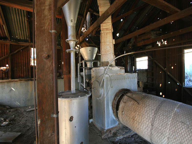 A look at the upper end of the Gould rotary kiln.  The heating unit maintained a temperature of 1200 to 1600 degrees in the roasting drum.  It burned nine gallons of diesel oil per ton of ore.