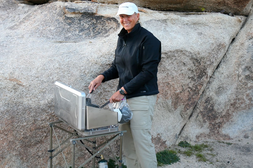 Jamie works on a carnitas, veggies and rice scramble as the temperatures drop and the wind picks up.