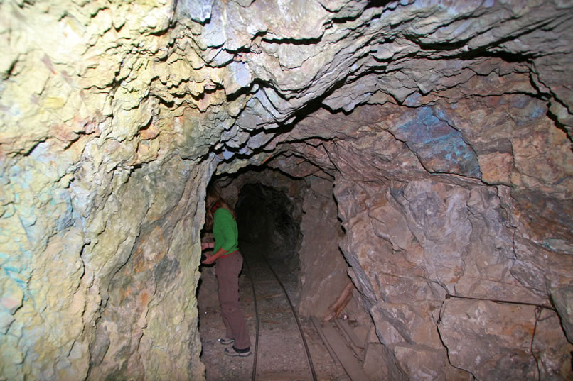 Just inside the entrance, Niki checks out some historic artifacts in a short side tunnel.