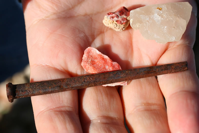 A large square nail and a few more colorful rocks are found.