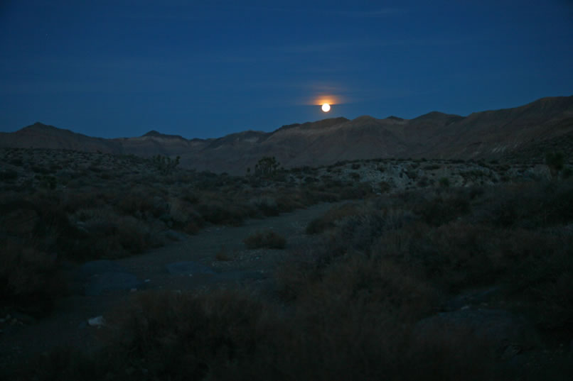 And then, as we follow the glowing red lights of the trucks in front, we're treated to a spectacular moonrise.