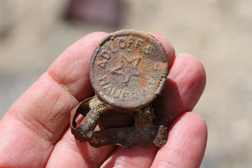 Lots of these were found scattered around among the bottles.  It appears to be a device to secure the cork in a bottle or to otherwise seal the contents.