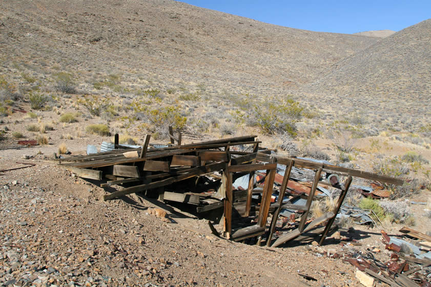 The remains of the foundation of a two story frame structure at the edge of the tailings dump.