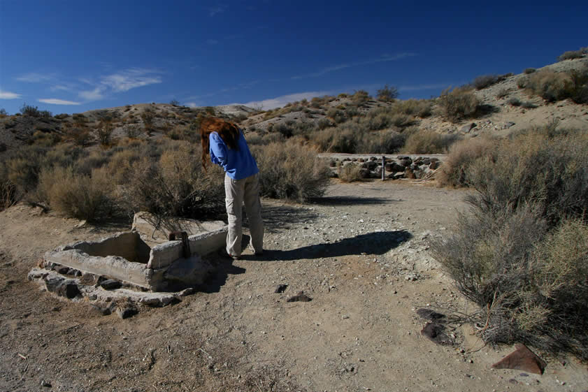 Niki's taking a look down into the hand dug Black Canyon Well.  In the past it's been known as Dove Springs and Pigeon Springs.  The current well appears on a map published in 1915 but this water source, be it well or spring, was most certainly in use in the 1870's and was undoubtedly an important stop on the wagon route through the canyon.  Of course Indian use of this spring predates everything.  Numerous flakes of jasper can be found nearby to attest to its prehistoric popularity.