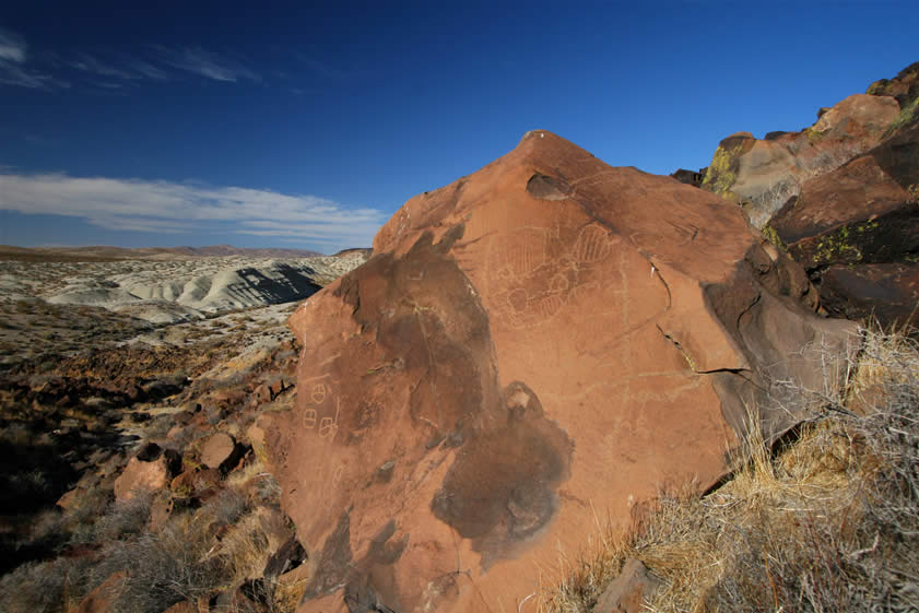 This wide angle shot from the front gives us a better idea of the vast amount of work that's present.  Wilson Turner, the originator of the Black Canyon project and author of The Rock Art of Black Canyon, feels that this boulder is the result of repeated carving by many peoples over thousands of years.  He further feels that it might be a type of tally in which various tribes record the number of times their group has traveled through the canyon.  Whatever the case, it's one impressive sight!