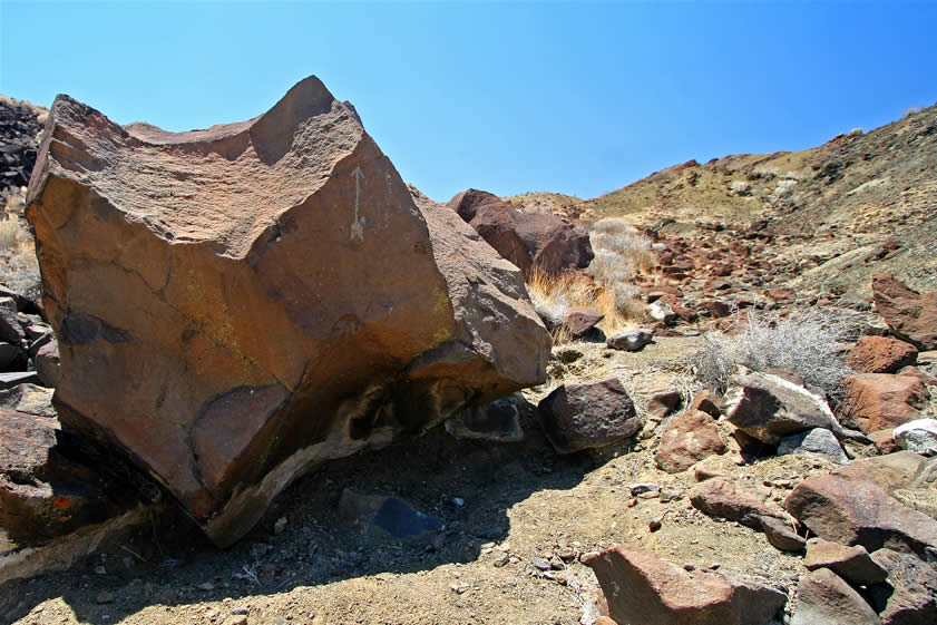 The deeply incised arrow certainly is rather unique.  It doesn't appear to be prehistoric.  The partial shelter under it seems to be blackened by fires and in old photos a rough rock wall can be seen that would have made it much more snug.  We guess that its purpose will probably never be known but it does create a nice little mystery!