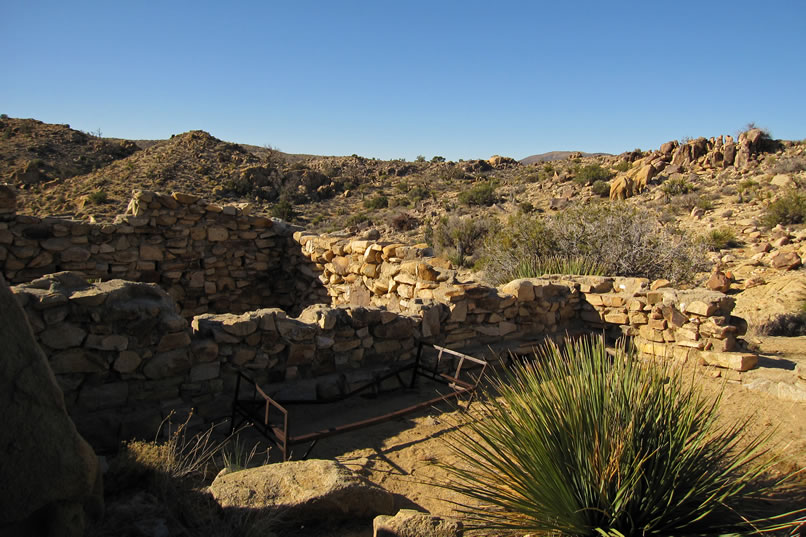 The early morning sun washes this old stacked stone cabin ruin with a warm glow.