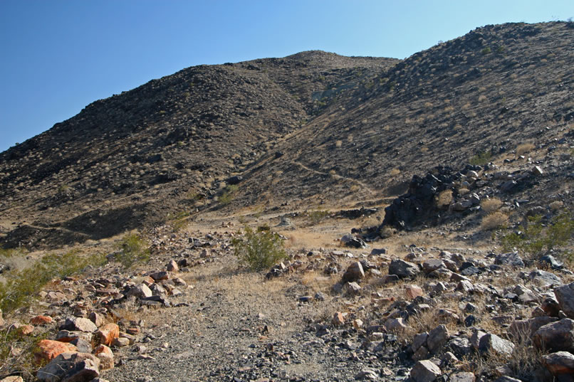 Where the steep path ends just below the saddle of the hill is the location of the shafts and cuts of the Hard Diggings Mine.  We're not going to be able to make it up there.  Sometimes you just have to know your limits.  We're at ours right now and we still have a couple of waterless miles to go before we reach the Jeep.  We'll just have to leave the climb up to the mine for another time.