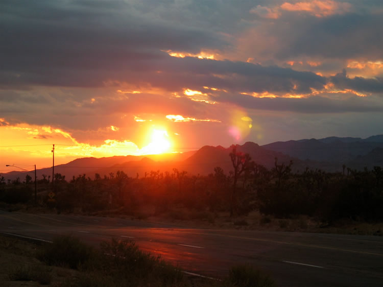 Hoping that the heavy desert rains of yesterday are over, we head east through a Joshua Tree sunrise toward our trailhead in the Old Woman Mountains.