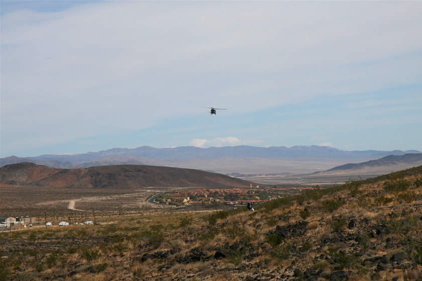 This low flying helicopter draws our eyes upward and gives us a nice view of the housing area of Fort Irwin peeping from around the ridge.