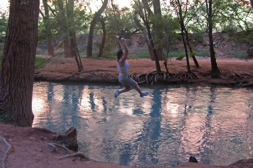 While Niki and Jamie are still up in the village feeding the dogs, Joyce and Jenny practice launching themselves into the river on the rope swing back at our campsite.