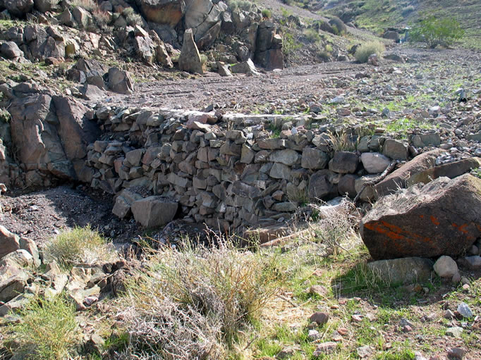 Just as we crest the last climb we come to a stone check dam.  A quick scan above the dam, though, shows no sign of a cabin.