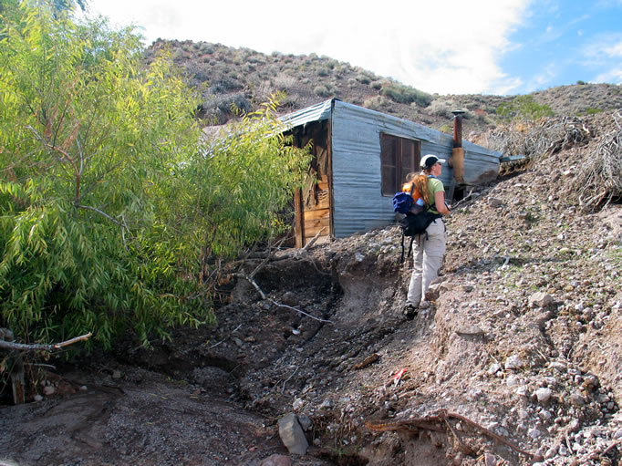 Erosion down the wash in front of the cabin has left it literally hanging on the edge.