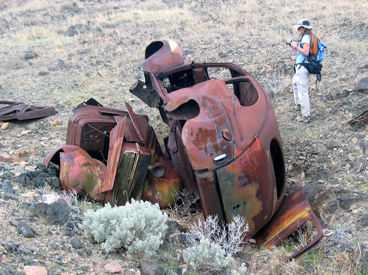 Tucked underneath the Ford is the front half of an older vehicle.
