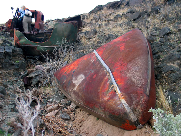 Down the wash from the Chevrolet truck cab are a few other car parts.
