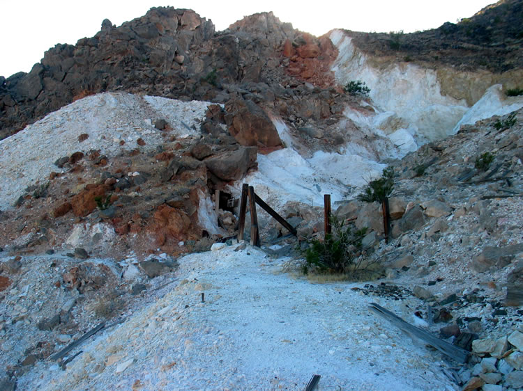 A caved in adit beneath the boulders.