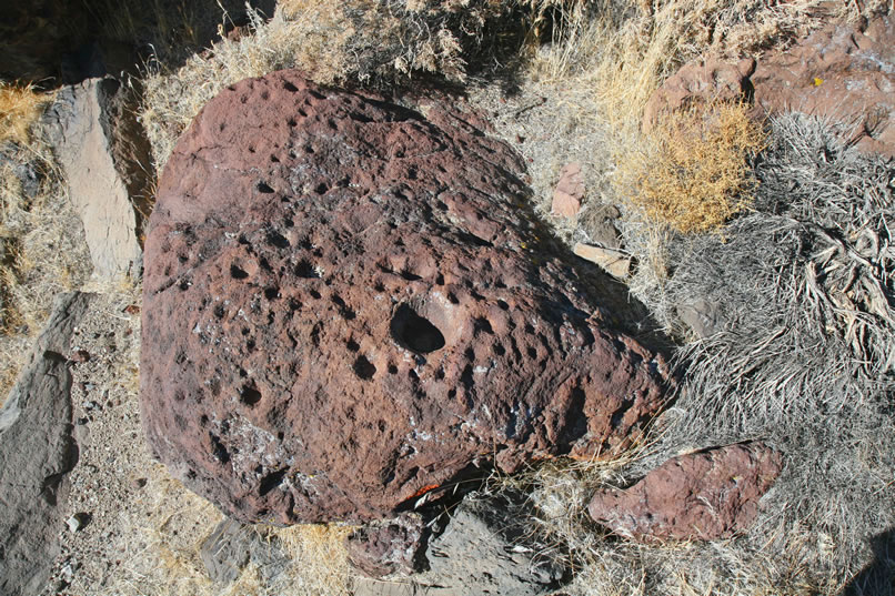 Finally, we drop down to the wash again and turn the corner into the wide spot that we've been eyeing.  Immediately, right at our feet, is a boulder in the wash that's covered with small cupules.