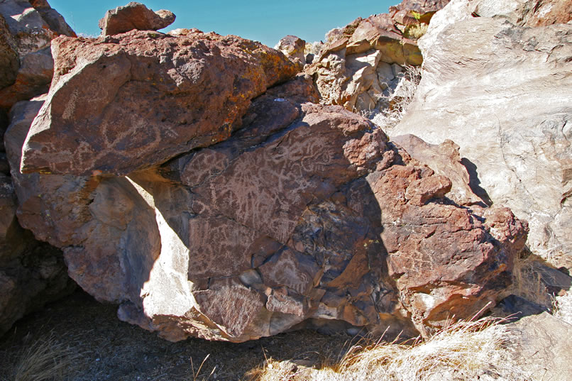 As we raise our heads to look around, we're awestruck with what we see.  All the rock faces that surround this little bowl are covered in petroglyphs.