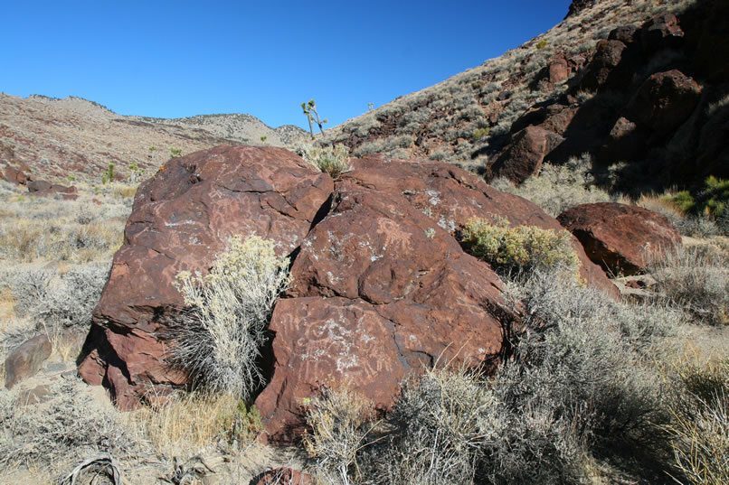 Figuring that we've seen all that this big boulder site has to offer, we once again continue up the canyon.  (We were wrong, of course, but luckily corrected our error on our way back down!)  Only a short distance away, we come to a colorful reddish boulder that pretty much marks the end to the petroglyphs.